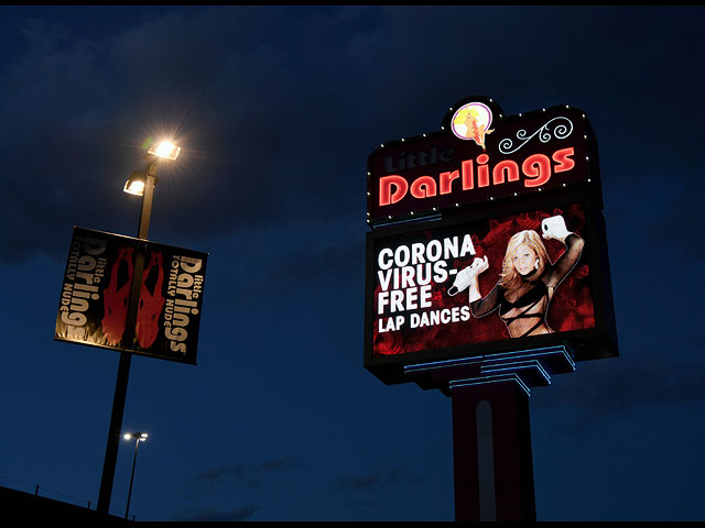 Вывеска на стрип-клубе Little Darlings в Лас-Вегасе рекламирует "танцы на коленях без коронавируса". 14 марта 2020 года