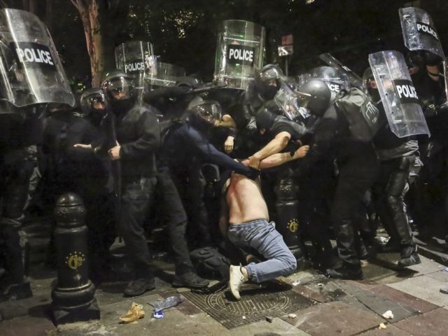 Opposition leader in Georgia beaten by police during protests against foreign agents law