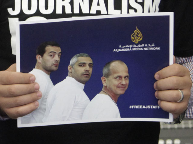 Портреты трех сотрудников "Аль-Джазиры", осужденных в Египте