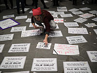 Митингующие расстелили большой плакат, на котором траурные сообщения с именами убитых женщин