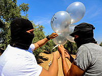 Боевики ХАМАС "украшают" "огненные шары" портретами Раэда Салаха