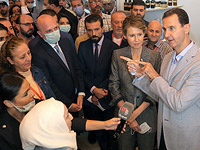 Асма Асад и Башар Асад на выставке в Дамаске