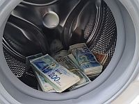 Задержаны подозреваемые в отмывании криптовалюты, прятавшие наличные в стиральной машине