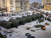 Сотрудники экстренных служб устанавливают палатки, где жители соседних многоквартирных домов могут согреться и переночевать. Киев, 25 января 2026 года.