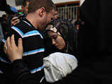 Джихад Машарауи и его жена с телом убитого сына. Газа, 15 ноября 2012 года