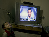 Мухаммад Ассаф на экране телевизора в одном из домов в Рафахе (юг сектора Газы)