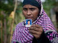 Представительница рохинджа с фотографией пропавшего сына в Бангладеше